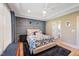 Charming bedroom features blue accent wall, stylish furniture and natural light at 9947 Nc Hwy 96 N, Selma, NC 27576