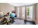Exercise room with equipment, weights, and a mounted TV, with a view of trees at 9947 Nc Hwy 96 N, Selma, NC 27576