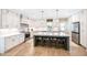 Bright kitchen with a large island, white cabinets, and stainless steel appliances, perfect for culinary enthusiasts at 9947 Nc Hwy 96 N, Selma, NC 27576