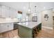 Stylish kitchen with an island, white cabinets, stainless steel appliances, and abundant natural light at 9947 Nc Hwy 96 N, Selma, NC 27576
