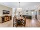 Open kitchen and dining area with modern appliances, stylish cabinetry, and a central island for entertaining guests at 9947 Nc Hwy 96 N, Selma, NC 27576