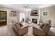 Comfortable living room with a fireplace, a modern ceiling fan, and plenty of seating, perfect for relaxation at 9947 Nc Hwy 96 N, Selma, NC 27576