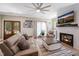 Cozy living room with modern furnishings, a stone fireplace, and elegant double doors that lead to the outdoors at 9947 Nc Hwy 96 N, Selma, NC 27576