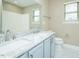 A well-lit bathroom with dual sinks, a granite countertop, and a large mirror enhances functionality at 1004 Longleaf Pine Pl, Mebane, NC 27302