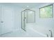 Bright bathroom featuring a glass enclosed shower and soaking tub at 1004 Longleaf Pine Pl, Mebane, NC 27302