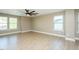 Spacious bedroom featuring hardwood floors and natural light from the many windows at 1004 Longleaf Pine Pl, Mebane, NC 27302