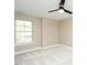 A comfortable bedroom features neutral paint, a ceiling fan, and a window offering natural light at 1004 Longleaf Pine Pl, Mebane, NC 27302
