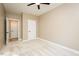 Neutral bedroom featuring carpet, a ceiling fan, and two doors at 1004 Longleaf Pine Pl, Mebane, NC 27302