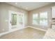 Open dining area with hardwood floors, large windows, and patio door access to a deck at 1004 Longleaf Pine Pl, Mebane, NC 27302