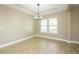 Charming dining room with modern chandelier and light wood grain floors at 1004 Longleaf Pine Pl, Mebane, NC 27302