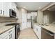 Open concept kitchen with stainless steel appliances and granite countertops at 1004 Longleaf Pine Pl, Mebane, NC 27302