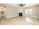 Bright living room featuring a modern fireplace, ceiling fan, and hardwood floors at 1004 Longleaf Pine Pl, Mebane, NC 27302