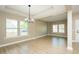Large living room with ample light from multiple windows at 1004 Longleaf Pine Pl, Mebane, NC 27302