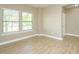 Bright living room featuring hardwood floors, a neutral color palette, and plenty of natural light at 1004 Longleaf Pine Pl, Mebane, NC 27302