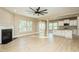 Open-concept living room featuring hardwood floors, fireplace, and an open view of the kitchen at 1004 Longleaf Pine Pl, Mebane, NC 27302