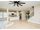 Spacious living room features hardwood floors, stainless steel appliances, and a modern staircase at 1004 Longleaf Pine Pl, Mebane, NC 27302