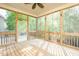 Cozy screened porch with wood floors and serene views of the surrounding greenery at 1004 Longleaf Pine Pl, Mebane, NC 27302