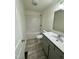 Bright bathroom features a tub-shower combo and a gray vanity with a marble countertop at 1010 Pool Rock Rd, Henderson, NC 27537