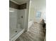 Bathroom showcasing a walk-in shower, soaking tub, and stylish tile accents, offering relaxation and functionality at 1010 Pool Rock Rd, Henderson, NC 27537