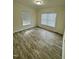 This bedroom features modern flooring and an abundance of natural light through a set of windows at 1010 Pool Rock Rd, Henderson, NC 27537