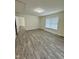 Inviting bedroom with wood-look floors and natural light, creating a relaxing and comfortable retreat at 1010 Pool Rock Rd, Henderson, NC 27537