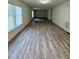 Open and spacious living room with bright windows, perfect for entertaining guests or relaxing at 1010 Pool Rock Rd, Henderson, NC 27537
