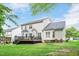 Expansive backyard with lush green lawn, deck and view of the house at 1027 Upchurch Farm Ln, Cary, NC 27519