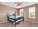 Bedroom featuring a four-poster bed with blue and white accents and a ceiling fan at 1027 Upchurch Farm Ln, Cary, NC 27519