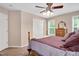 Bedroom with neutral walls, carpet, closet, two windows with blinds, and ceiling fan with lights at 1027 Upchurch Farm Ln, Cary, NC 27519