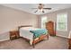 Bedroom with neutral walls, carpet, two windows with blinds, and a ceiling fan with lights at 1027 Upchurch Farm Ln, Cary, NC 27519