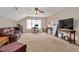 Large bonus room features a comfortable leather sofa, work area, and entertainment setup at 1027 Upchurch Farm Ln, Cary, NC 27519