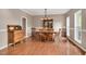Traditional dining room featuring hardwood floors, vintage furniture, and natural light from the surrounding windows at 1027 Upchurch Farm Ln, Cary, NC 27519