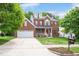 Charming two-story brick home with red shutters, landscaped lawn and a two-car garage at 1027 Upchurch Farm Ln, Cary, NC 27519