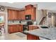 Updated kitchen with granite countertops, stainless steel appliances, tile backsplash, and ample cabinet space at 1027 Upchurch Farm Ln, Cary, NC 27519