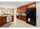 Bright kitchen featuring granite countertops, modern appliances, and ample storage with views into the breakfast nook at 1027 Upchurch Farm Ln, Cary, NC 27519