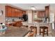 Gourmet kitchen featuring granite countertops, cherry cabinets, a kitchen island with bar seating, and modern appliances at 1027 Upchurch Farm Ln, Cary, NC 27519