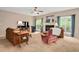 Cozy living room with a fireplace, plush seating, a ceiling fan, and natural light for a relaxing atmosphere at 1027 Upchurch Farm Ln, Cary, NC 27519