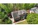 Bird's-eye view of the home with a large roof, manicured lawn, mature trees, and black shutters at 103 Ticonderoga Rd, Cary, NC 27519