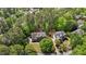 Stunning aerial view of two homes nestled in a lush, green, wooded neighborhood with mature trees and well-manicured lawns at 103 Ticonderoga Rd, Cary, NC 27519