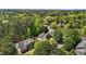 Serene aerial shot of homes nestled amongst a lush green forest with blue skies above at 103 Ticonderoga Rd, Cary, NC 27519