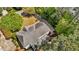 Aerial view of a house with a gray roof, surrounded by trees and lush greenery at 103 Ticonderoga Rd, Cary, NC 27519