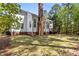 This beautiful yard features a brick chimney, brick foundation, and manicured lawn at 103 Ticonderoga Rd, Cary, NC 27519