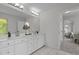 Light and airy bathroom with double sink vanity, large mirror, and neutral-toned flooring at 103 Ticonderoga Rd, Cary, NC 27519