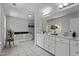 Bright bathroom featuring a soaking tub with black tiling and white vanity with dual sinks and elegant fixtures at 103 Ticonderoga Rd, Cary, NC 27519