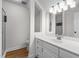 Well-lit bathroom features wood flooring, a glass-door shower, and a white vanity with ample storage at 103 Ticonderoga Rd, Cary, NC 27519