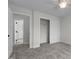 Bedroom featuring closet with sliding doors and neutral colored carpet throughout at 103 Ticonderoga Rd, Cary, NC 27519