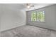 Neutral bedroom with large window providing natural light and a ceiling fan for added comfort at 103 Ticonderoga Rd, Cary, NC 27519