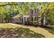 Striking brick facade with white trim, balcony, manicured lawn, and lush landscaping at 103 Ticonderoga Rd, Cary, NC 27519