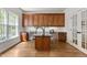Bright home office features custom wood cabinetry, black countertop, and hardwood floors at 103 Ticonderoga Rd, Cary, NC 27519