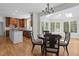 Open kitchen dining area with hardwood floors, natural light, and modern lighting at 103 Ticonderoga Rd, Cary, NC 27519